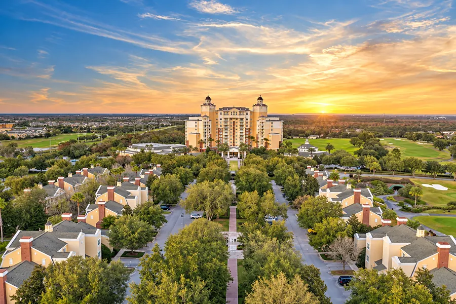 The Reunion Grande and tree-lined resort avenues at sunset